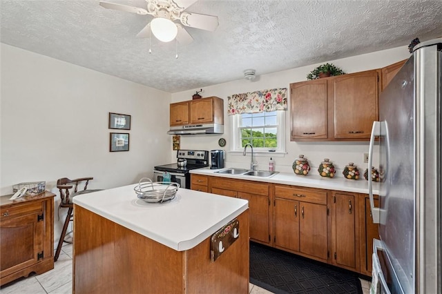 73 Hartman Rd, Green/Commdre/Prchse, PA 15759 - kitchen featuring appliances with stainless steel finishes, a sink, under cabinet range hood, light tile patterned floors, and a textured ceiling