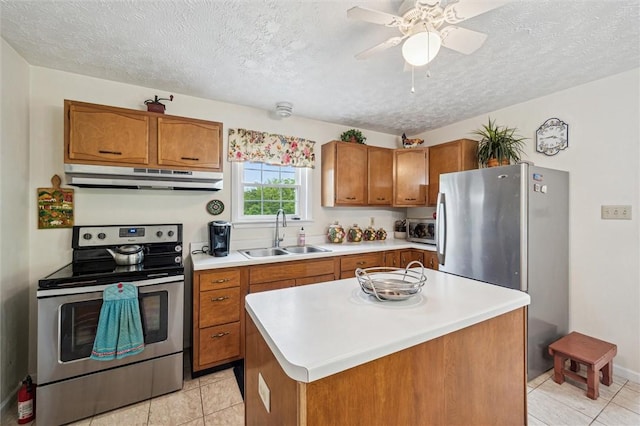 73 Hartman Rd, Green/Commdre/Prchse, PA 15759 - kitchen with appliances with stainless steel finishes, a sink, under cabinet range hood, brown cabinetry, and a textured ceiling