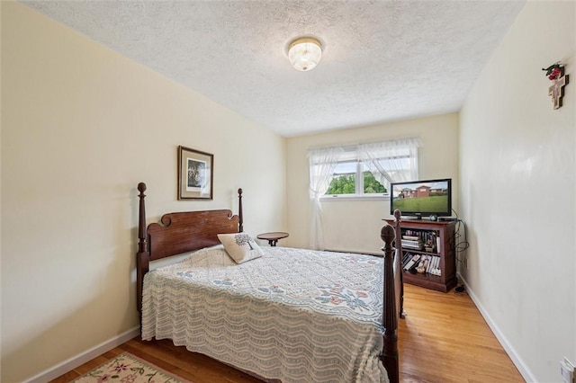73 Hartman Rd, Green/Commdre/Prchse, PA 15759 - bedroom with a textured ceiling, wood finished floors, and baseboards