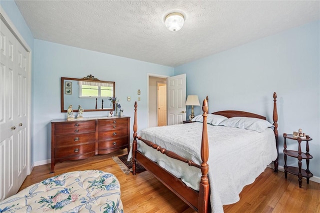 73 Hartman Rd, Green/Commdre/Prchse, PA 15759 - bedroom featuring a closet, light wood-type flooring, a textured ceiling, and baseboards