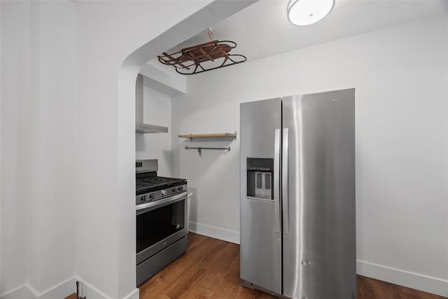 3919 Howley St, Lawrenceville, PA 15224 - kitchen with stainless steel appliances, baseboards, arched walkways, and wood finished floors
