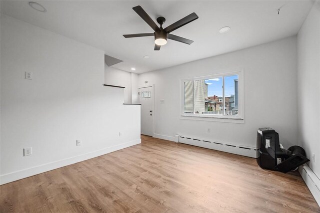 3919 Howley St, Lawrenceville, PA 15224 - unfurnished living room with a baseboard radiator, ceiling fan, wood finished floors, baseboards, and recessed lighting
