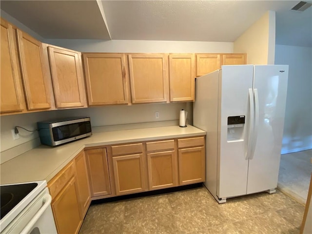 350 Hidden Ridge Ct Unit 302, South Park, PA 15129 - kitchen featuring white fridge with ice dispenser, stainless steel microwave, light countertops, and light brown cabinets