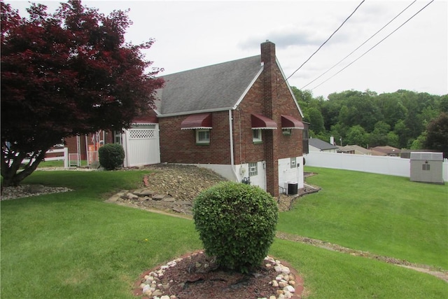 12840 Lincoln Way N, Huntingdon, PA 15642 - view of side of property featuring brick siding, a chimney, roof with shingles, and cooling unit