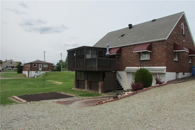 12840 Lincoln Way N, Huntingdon, PA 15642 - rear view of property with a shingled roof, brick siding, a sunroom, and a yard