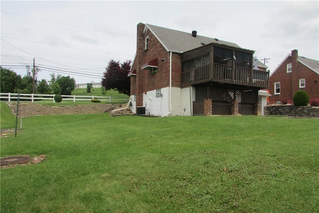 12840 Lincoln Way N, Huntingdon, PA 15642 - rear view of property featuring a sunroom, brick siding, and a shingled roof