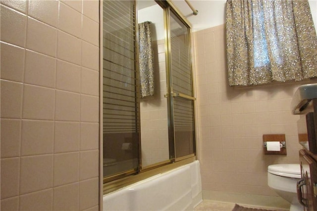 12840 Lincoln Way N, Huntingdon, PA 15642 - bathroom with tile walls, combined bath / shower with glass door, and toilet