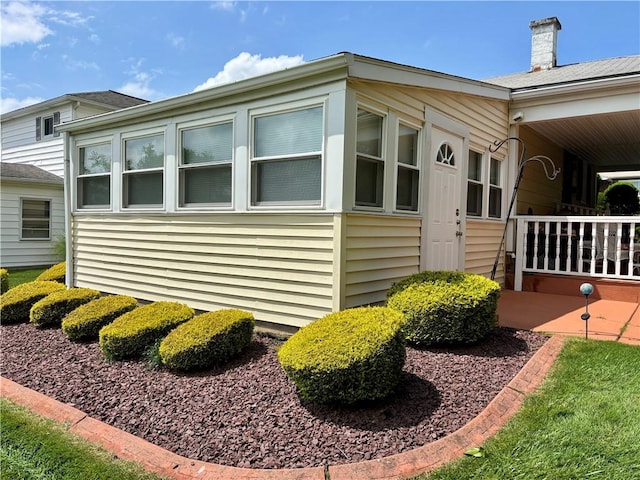 11 Worthington Ave, Neshannock Twp, PA 16105 - view of side of home featuring a chimney and a porch