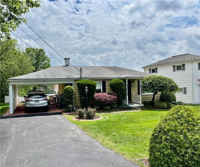 11 Worthington Ave, Neshannock Twp, PA 16105 - view of front of house featuring driveway, a front yard, a carport, and a chimney