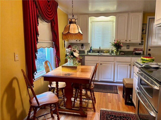 11 Worthington Ave, Neshannock Twp, PA 16105 - kitchen with white cabinets, light wood-style floors, a sink, range with two ovens, and healthy amount of natural light