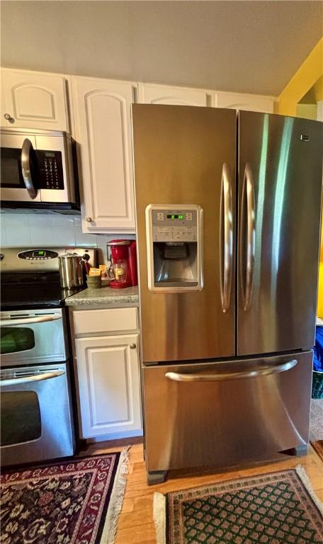 11 Worthington Ave, Neshannock Twp, PA 16105 - kitchen with appliances with stainless steel finishes, light wood-type flooring, and white cabinets