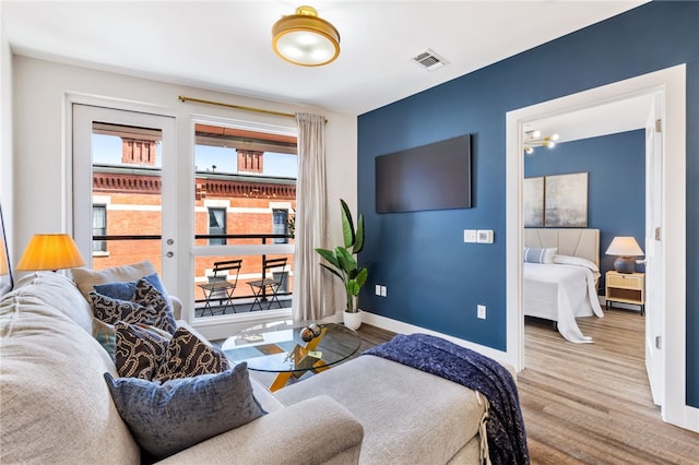 3725 Butler St Unit 406, Lawrenceville, PA 15201 - living area featuring wood finished floors, baseboards, and a chandelier