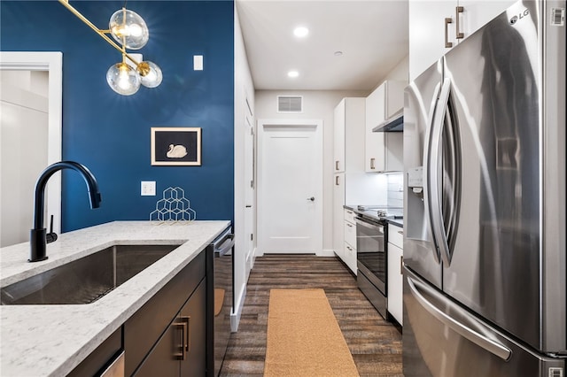 3725 Butler St Unit 406, Lawrenceville, PA 15201 - kitchen with stainless steel appliances, a sink, dark wood-style flooring, white cabinetry, and light stone counters