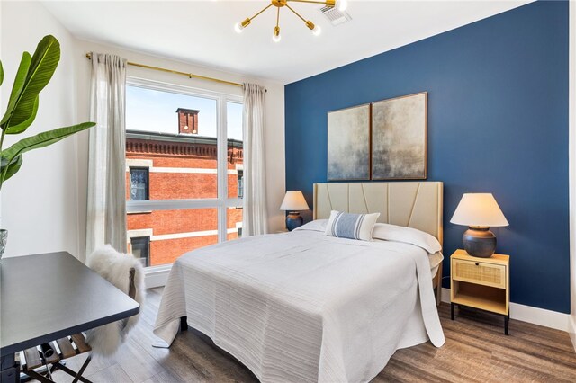 3725 Butler St Unit 406, Lawrenceville, PA 15201 - bedroom with wood finished floors and a chandelier