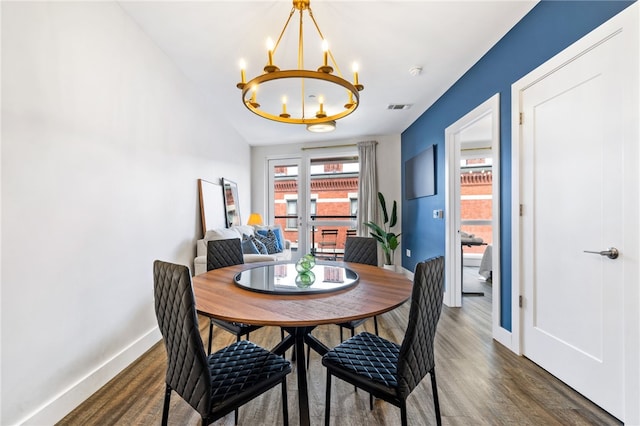 3725 Butler St Unit 406, Lawrenceville, PA 15201 - dining area with a chandelier, baseboards, and wood finished floors