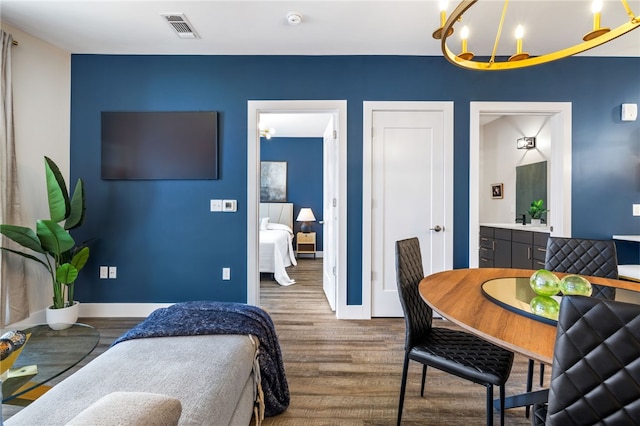 3725 Butler St Unit 406, Lawrenceville, PA 15201 - dining space featuring wood finished floors, a chandelier, and baseboards