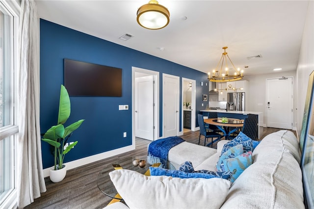 3725 Butler St Unit 406, Lawrenceville, PA 15201 - living room featuring a chandelier, baseboards, and dark wood-style floors