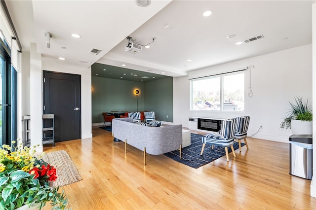3725 Butler St Unit 406, Lawrenceville, PA 15201 - living room with healthy amount of natural light, light wood-style floors, a glass covered fireplace, baseboards, and recessed lighting