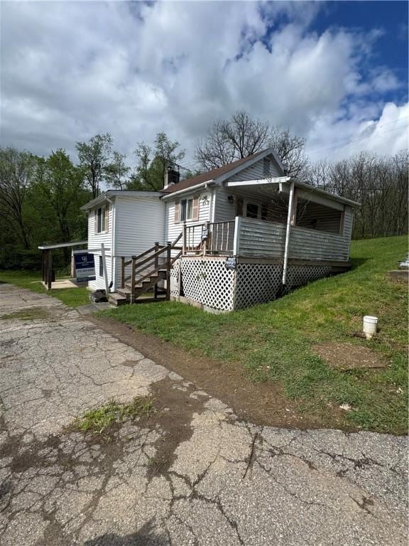 5 Navoski Ln, Smith, PA 15021 - manufactured / mobile home featuring a front lawn, driveway, and a chimney