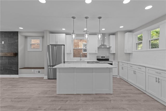 748 Anaheim St, Schenley Heights, PA 15219 - kitchen with stainless steel appliances, a sink, wall chimney exhaust hood, white cabinetry, and recessed lighting