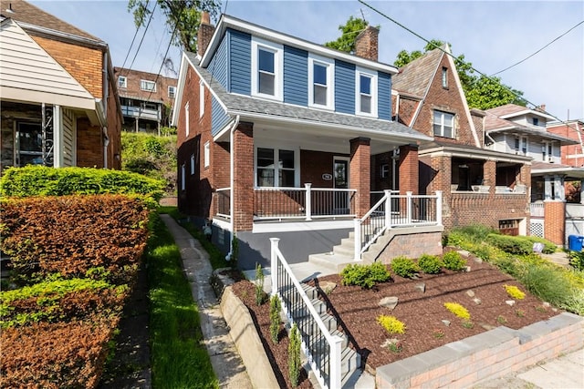748 Anaheim St, Schenley Heights, PA 15219 - view of front facade with a chimney, covered porch, and brick siding