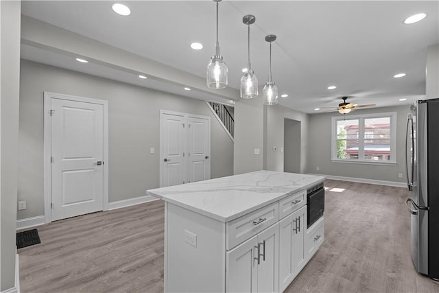 748 Anaheim St, Schenley Heights, PA 15219 - kitchen featuring freestanding refrigerator, black microwave, baseboards, recessed lighting, and white cabinets