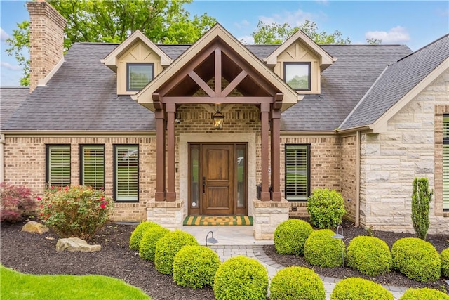 2293 Country Club Dr, Upper St Clair, PA 15241 - property entrance with a shingled roof, stone siding, and a chimney