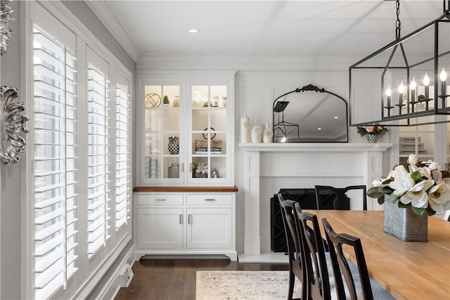 2293 Country Club Dr, Upper St Clair, PA 15241 - dining room with healthy amount of natural light, dark wood-style flooring, crown molding, a chandelier, and a fireplace with raised hearth