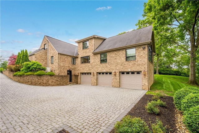 2293 Country Club Dr, Upper St Clair, PA 15241 - view of side of property with an attached garage, decorative driveway, brick siding, and a lawn