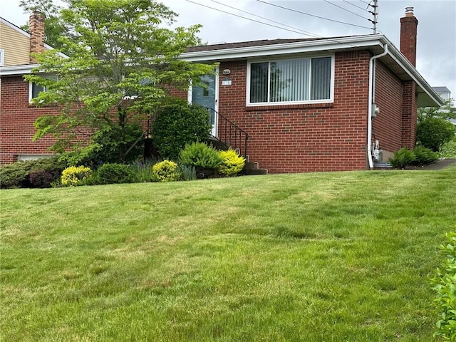 170 William Cir, Stowe Twp, PA 15136 - view of side of property featuring a chimney, brick siding, and a lawn