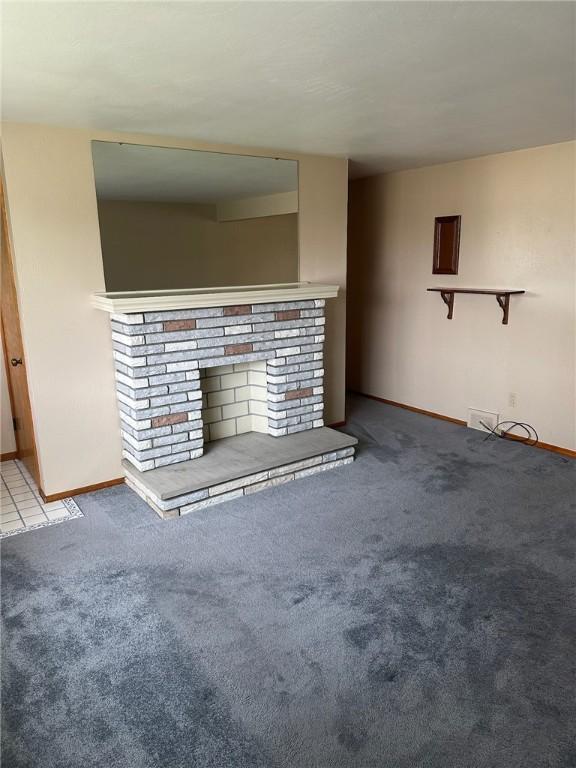 170 William Cir, Stowe Twp, PA 15136 - unfurnished living room with carpet, baseboards, and a fireplace