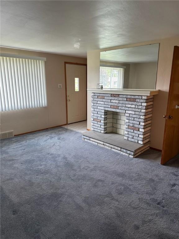 170 William Cir, Stowe Twp, PA 15136 - unfurnished living room with carpet and a fireplace