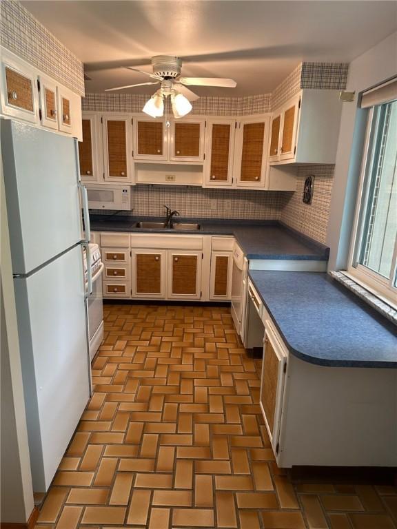 170 William Cir, Stowe Twp, PA 15136 - kitchen featuring white appliances, dark countertops, a sink, and decorative backsplash