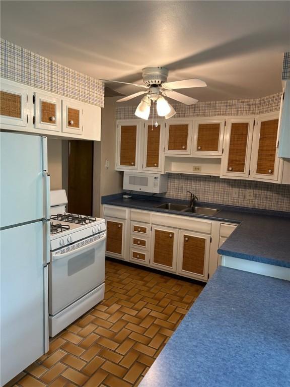 170 William Cir, Stowe Twp, PA 15136 - kitchen with white appliances, a sink, dark countertops, brick patterned floors, and a ceiling fan