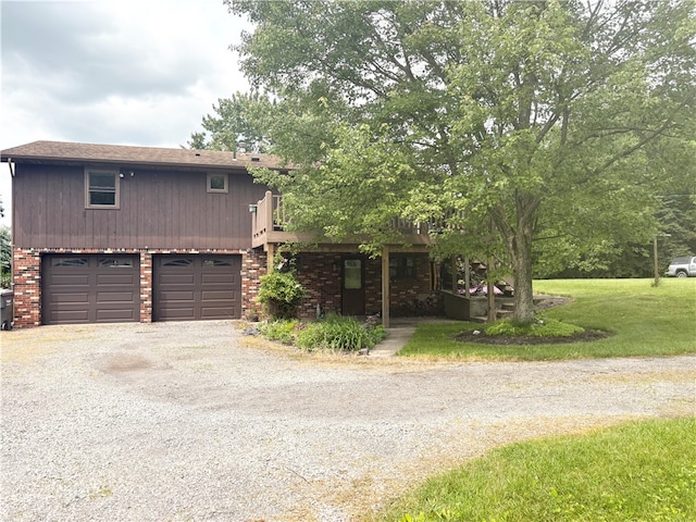 199 Lyon Ln, Lancaster Twp, PA 16037 - view of front facade with gravel driveway, brick siding, an attached garage, and a front yard