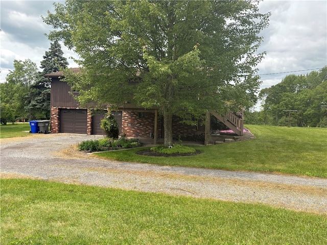 199 Lyon Ln, Lancaster Twp, PA 16037 - view of home's exterior featuring gravel driveway, a lawn, an attached garage, and stairway