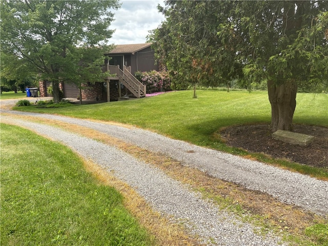 199 Lyon Ln, Lancaster Twp, PA 16037 - view of grassy yard featuring stairway, driveway, and a garage