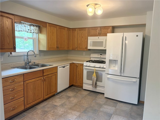 199 Lyon Ln, Lancaster Twp, PA 16037 - kitchen featuring white appliances, a sink, brown cabinetry, and light countertops