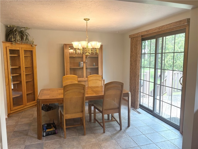 199 Lyon Ln, Lancaster Twp, PA 16037 - dining space featuring a chandelier, a textured ceiling, and light tile patterned flooring