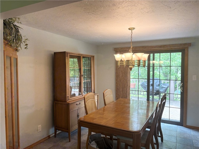 199 Lyon Ln, Lancaster Twp, PA 16037 - dining area featuring a chandelier, a textured ceiling, and light stone finish floors