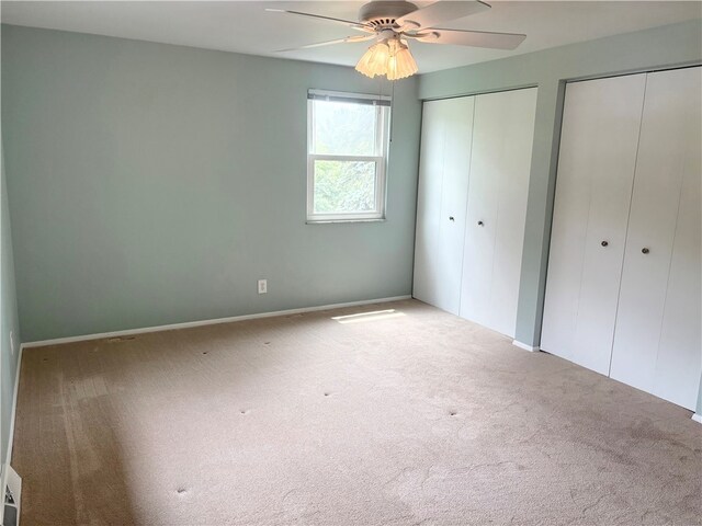 199 Lyon Ln, Lancaster Twp, PA 16037 - unfurnished bedroom featuring multiple closets, carpet flooring, and a ceiling fan