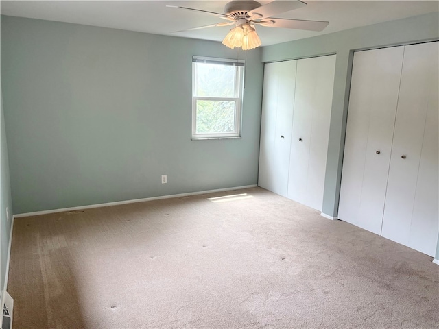 199 Lyon Ln, Lancaster Twp, PA 16037 - unfurnished bedroom with multiple closets, carpet floors, and ceiling fan