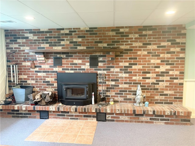 199 Lyon Ln, Lancaster Twp, PA 16037 - detailed view of a paneled ceiling, a wood stove, and carpet flooring