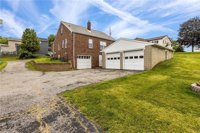 1311 Agnew Ave, Hopewell Twp Bea, PA 15001 - view of side of home with driveway, a garage, a lawn, brick siding, and a chimney