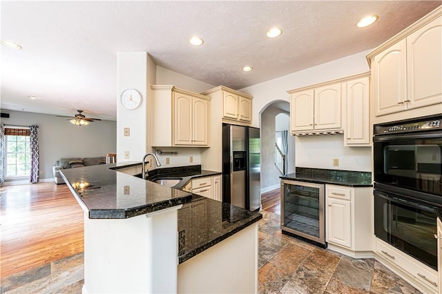1500 Fitzgerald Ct, Unity Twp, PA 15601 - kitchen featuring stainless steel refrigerator with ice dispenser, wine cooler, cream cabinets, a sink, and recessed lighting