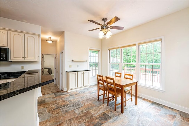 1500 Fitzgerald Ct, Unity Twp, PA 15601 - dining area with ceiling fan, baseboards, and stone tile flooring