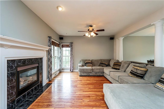 1500 Fitzgerald Ct, Unity Twp, PA 15601 - living area featuring light wood-style flooring, a high end fireplace, ceiling fan, and ornate columns