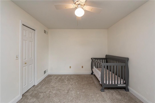 1500 Fitzgerald Ct, Unity Twp, PA 15601 - unfurnished bedroom with carpet flooring, baseboards, ceiling fan, and a crib