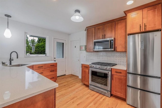 501 Parkview Dr, Mt Lebanon, PA 15243 - kitchen with appliances with stainless steel finishes, a sink, brown cabinetry, light wood-style flooring, and recessed lighting