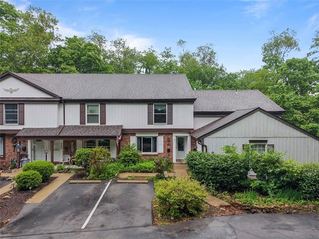 402 Hunting Creek Rd, Canonsburg, PA 15317 - multi unit property featuring uncovered parking, brick siding, roof with shingles, and covered porch